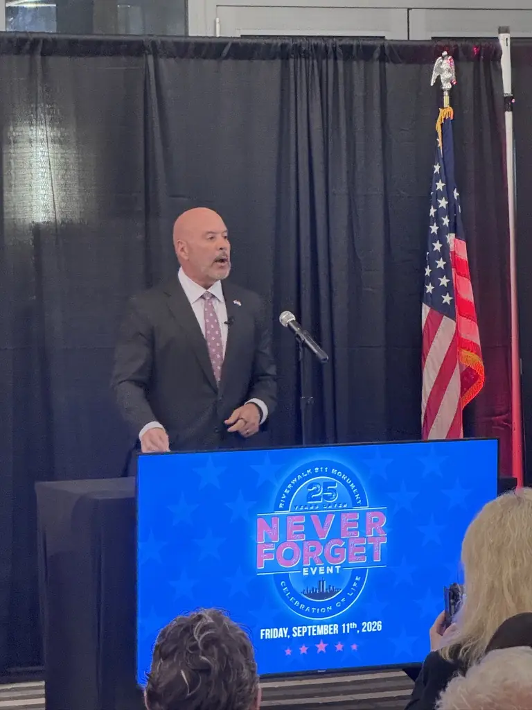A speaker at the Never Forget podium.
