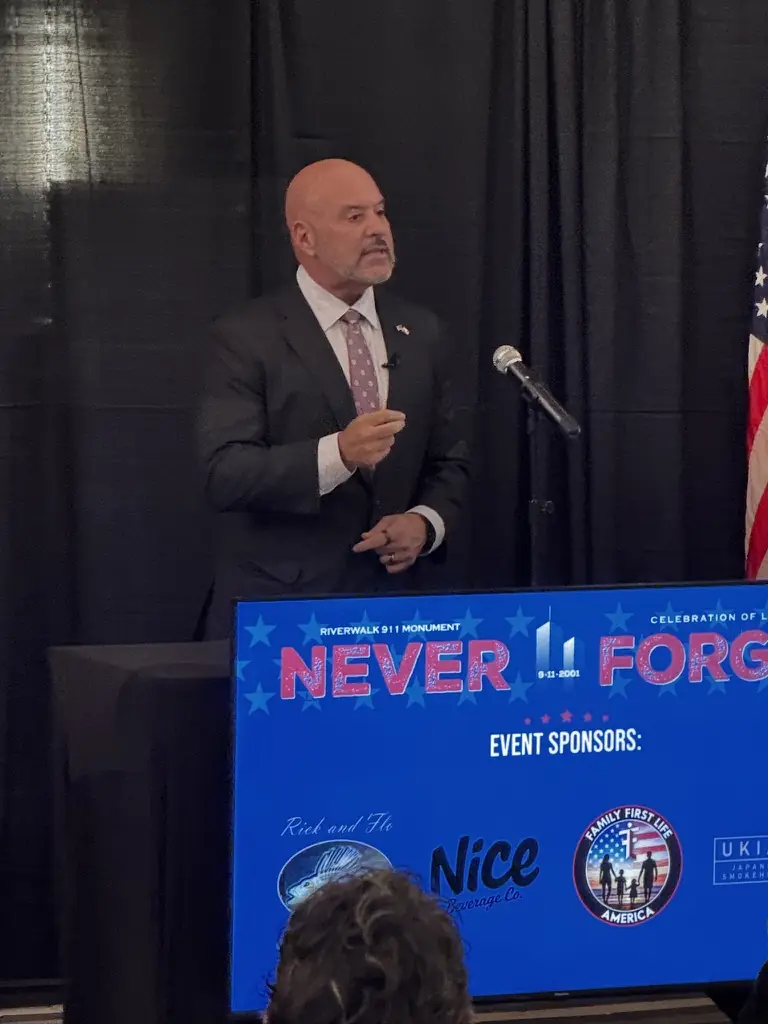 A speaker at the podium during the program.